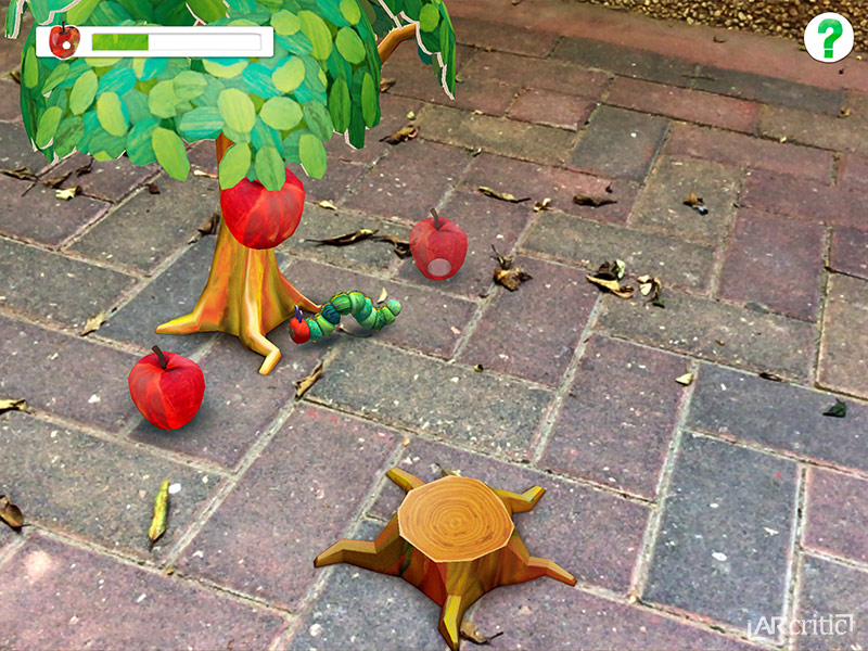 Playing My Very Hungery Caterpillar AR game on a pavement